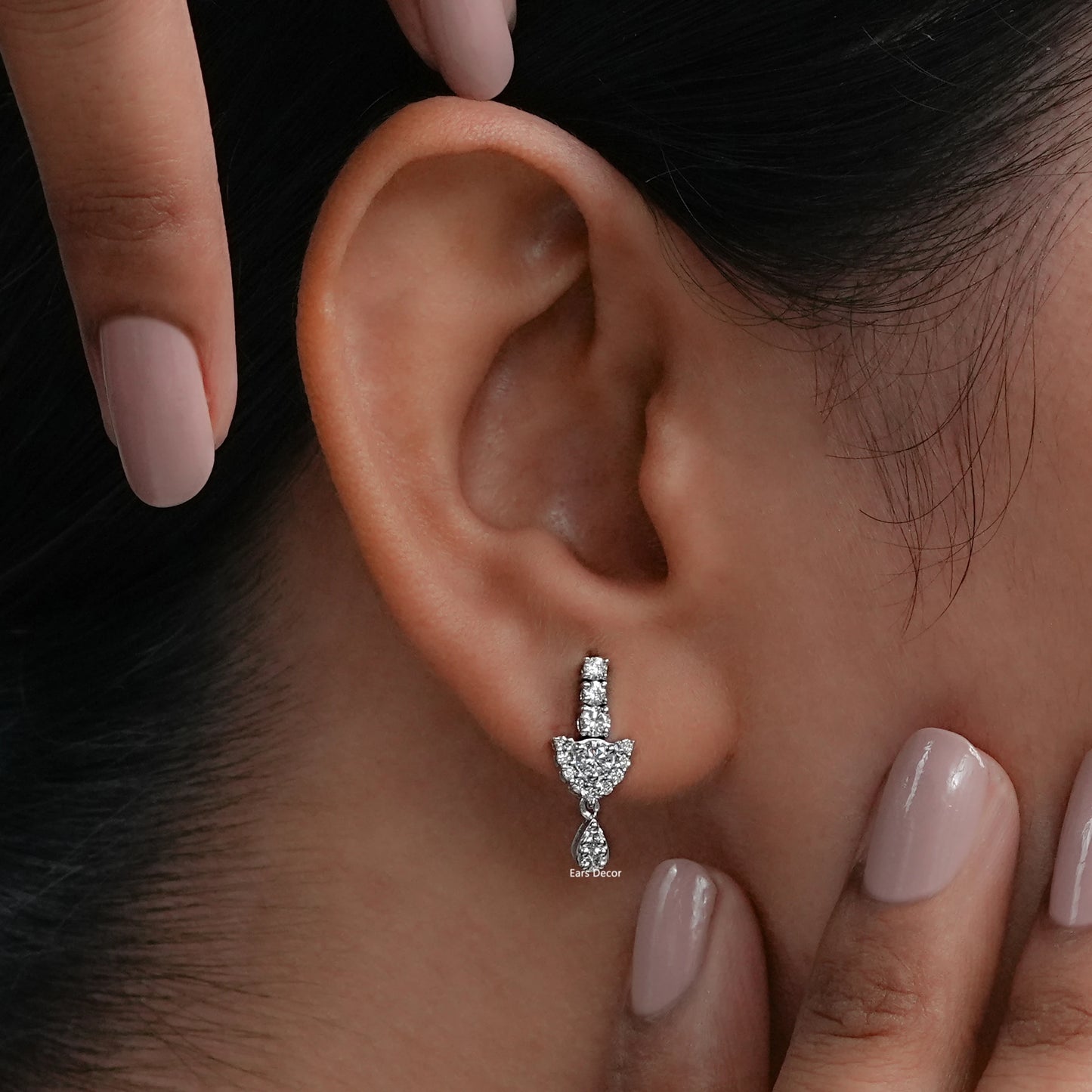 Round cut lab diamond dangle earrings worn on lobe showing linear stud top with cluster drop