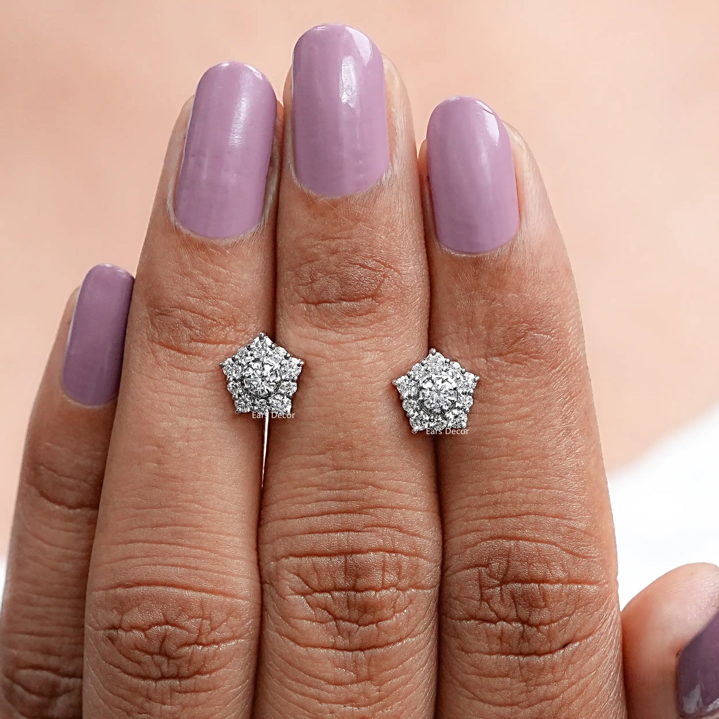 pentagon diamond stud earrings front view on fingers