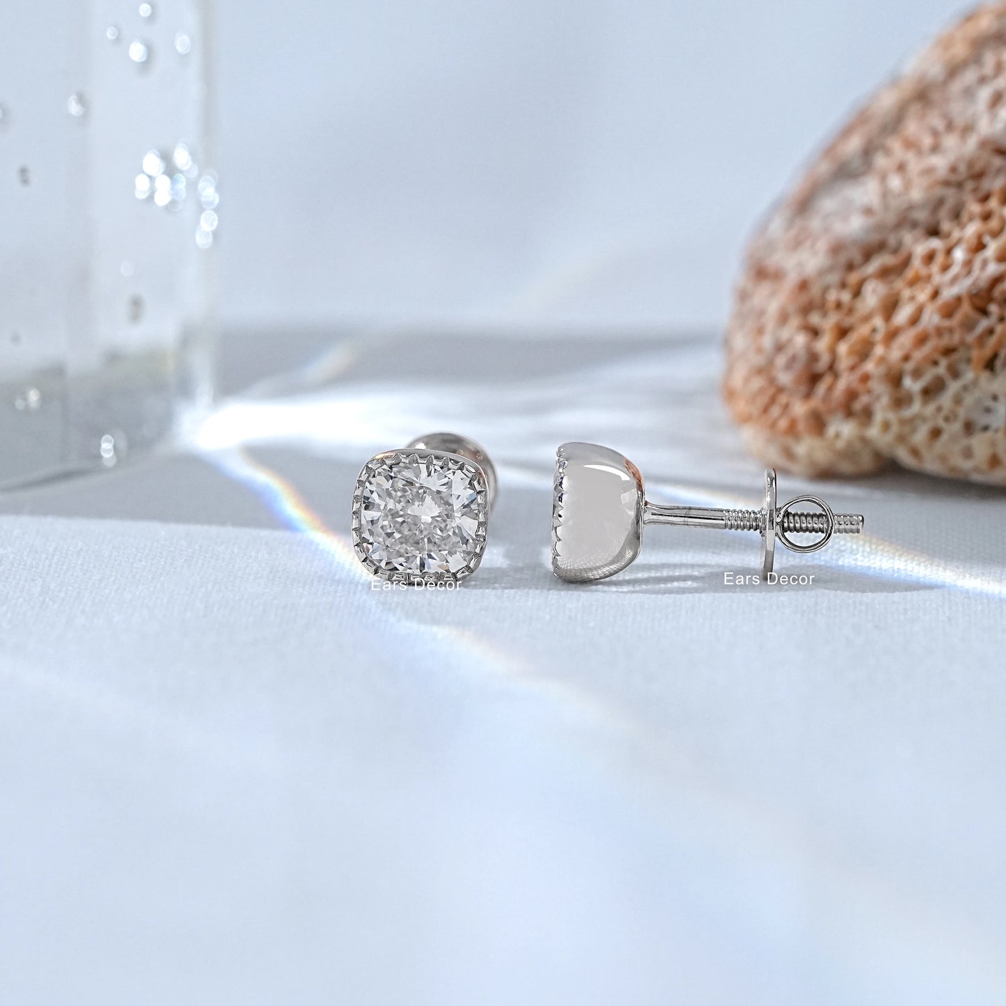 Matched milgrain diamond earrings resting on the palm revealing the high polish finish and the precise hand finished detailing of the golden mount