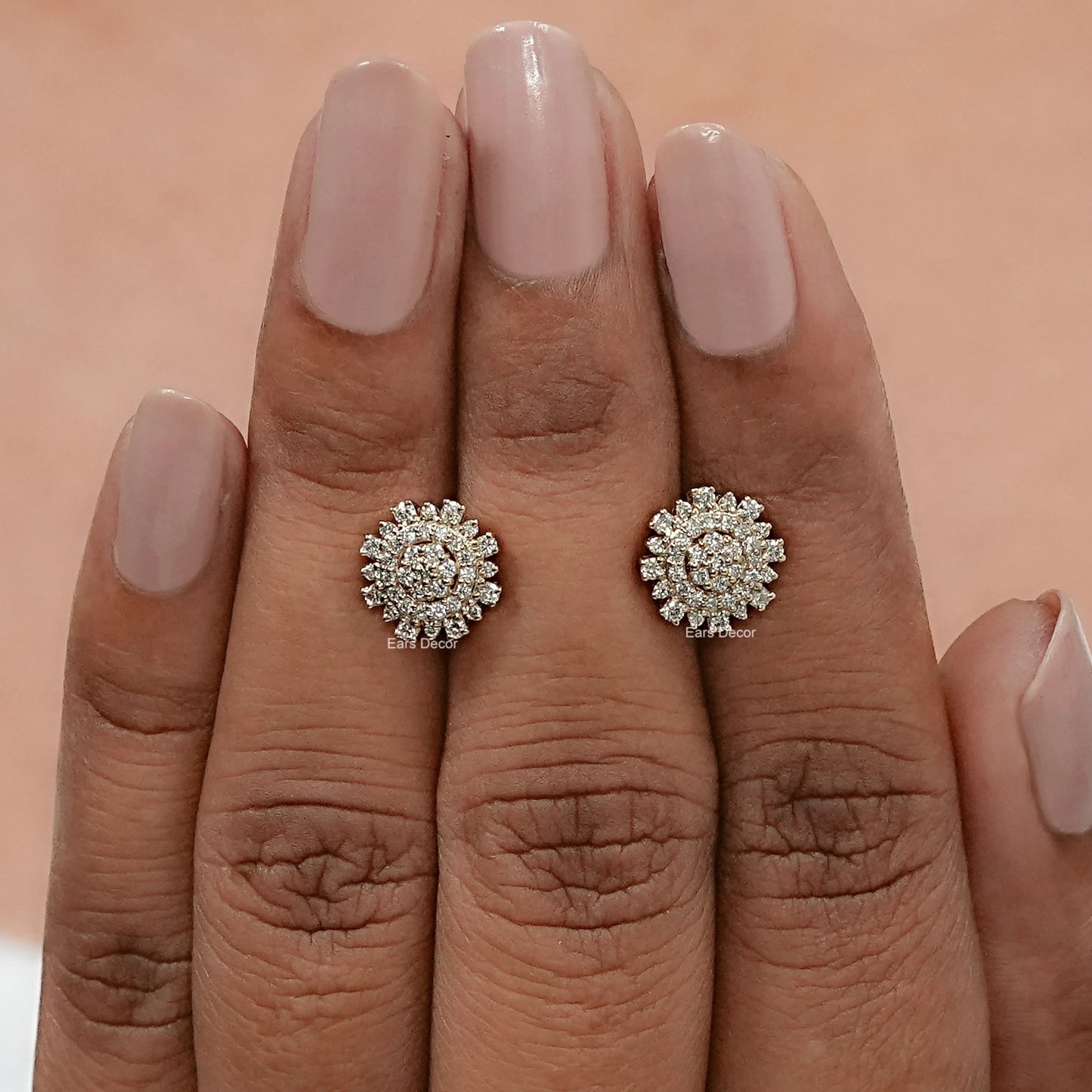 front view of round diamond cluster earrings displayed on fingers