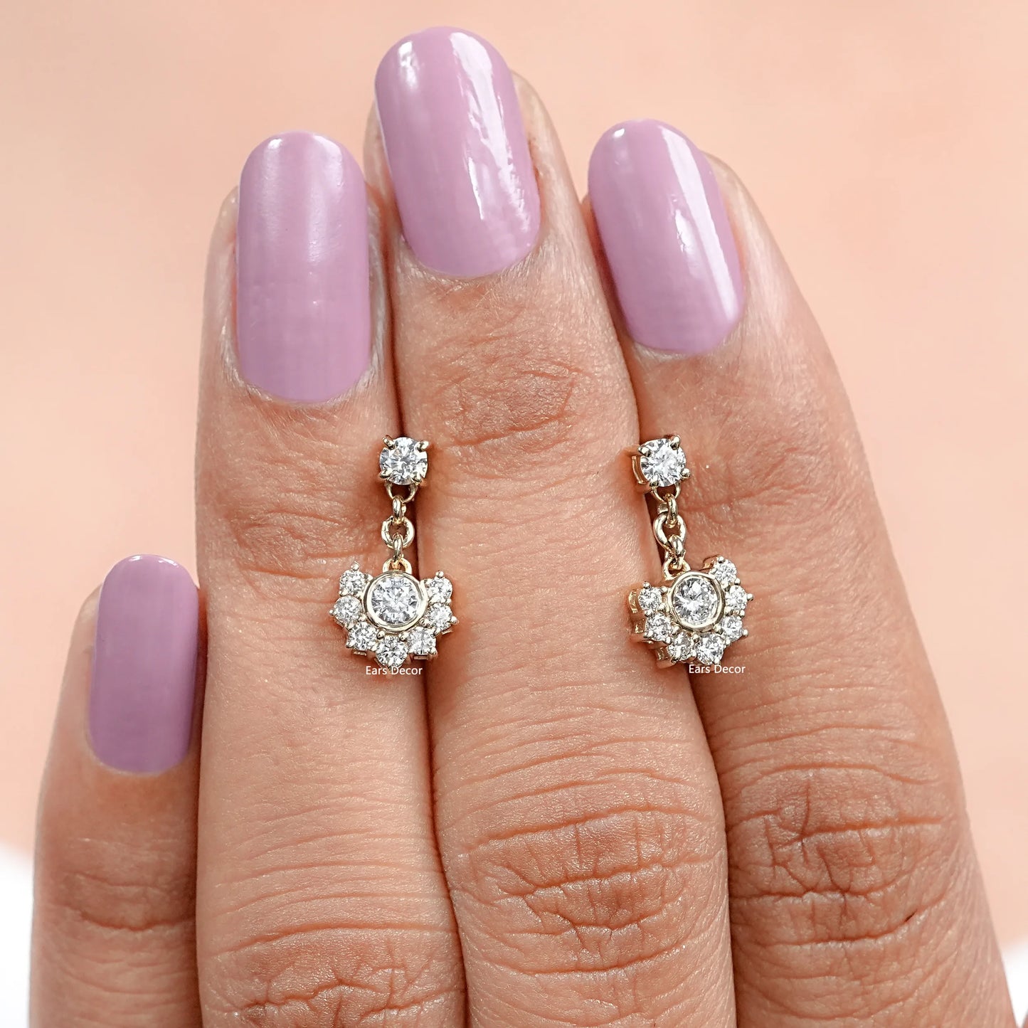 round cut half halo diamond earrings close view on fingers