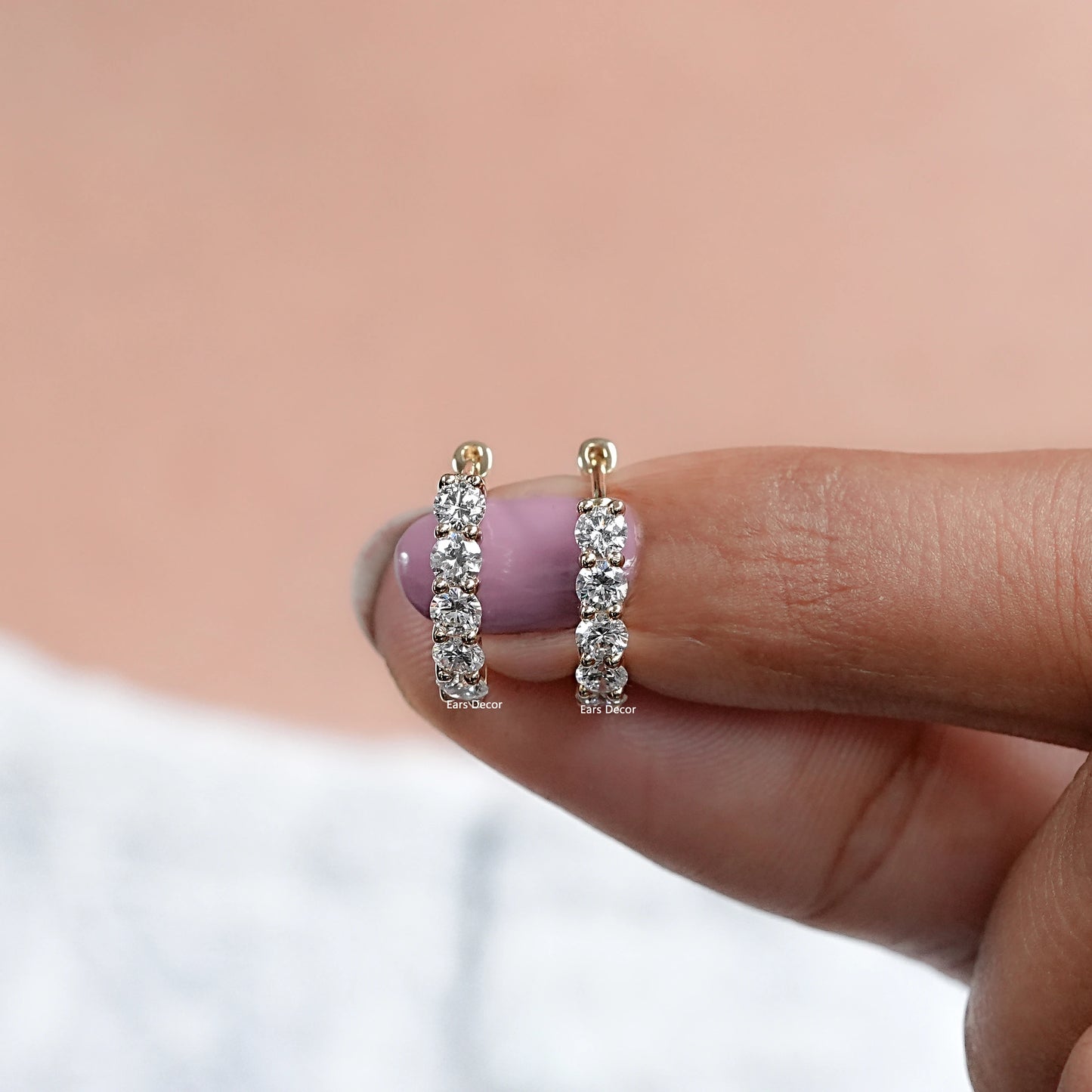 vs clarity round five stone diamond hoops shown on fingers