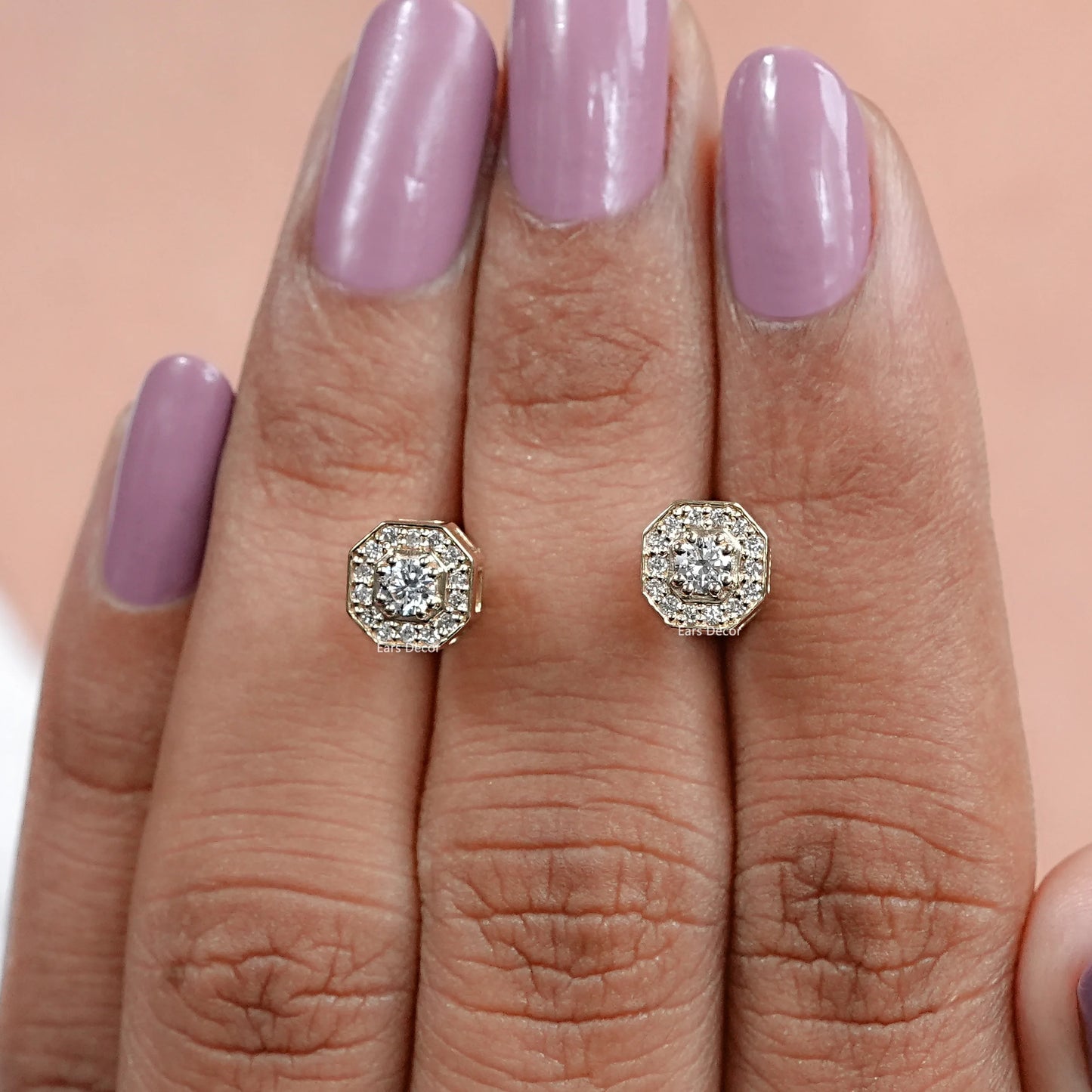 brilliant cut real diamond earrings with an octagon shape cluster design displayed on fingers