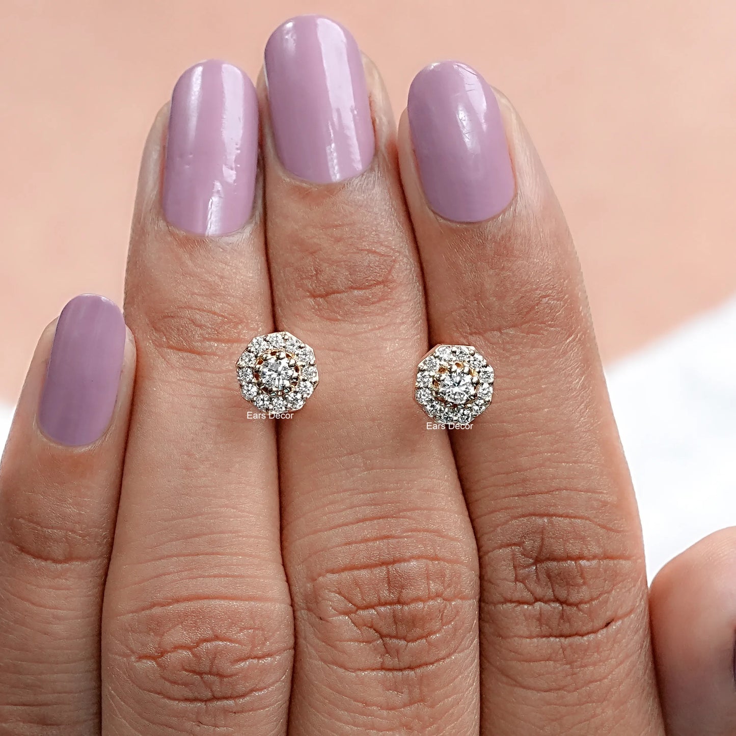 front view of round shaped diamond halo studs shown on fingers