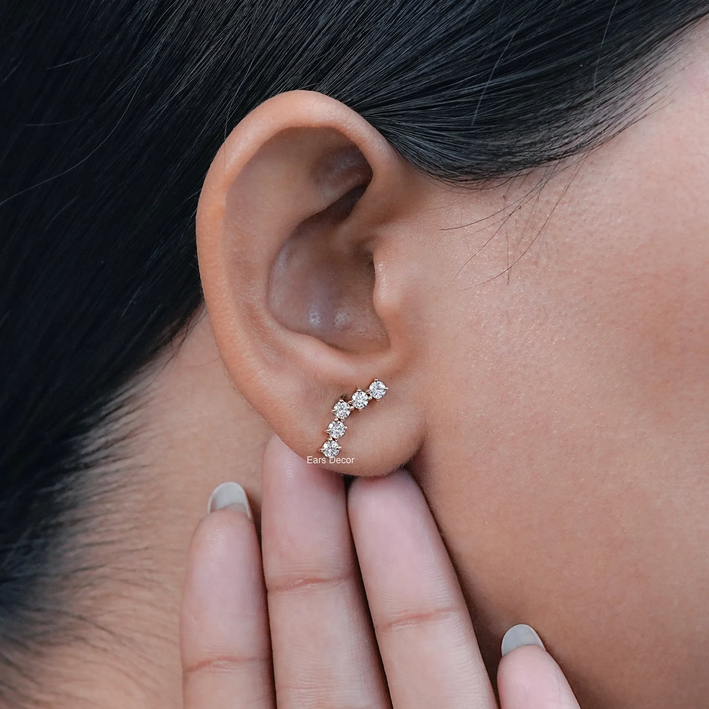 natural curved diamond stud earrings worn on the ear with a secure back design