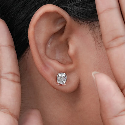 Close-up of a person wearing Old Mine Cushion Cut CVD Diamond Stud Earrings in silver.