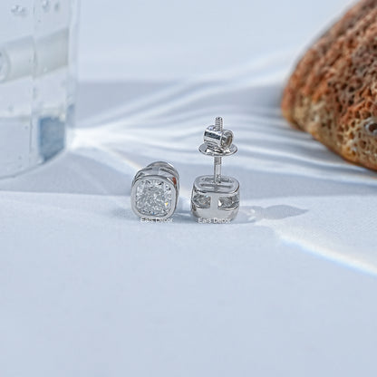 Moissanite cushion cut diamond stud earrings front back view white satin coral glass prop