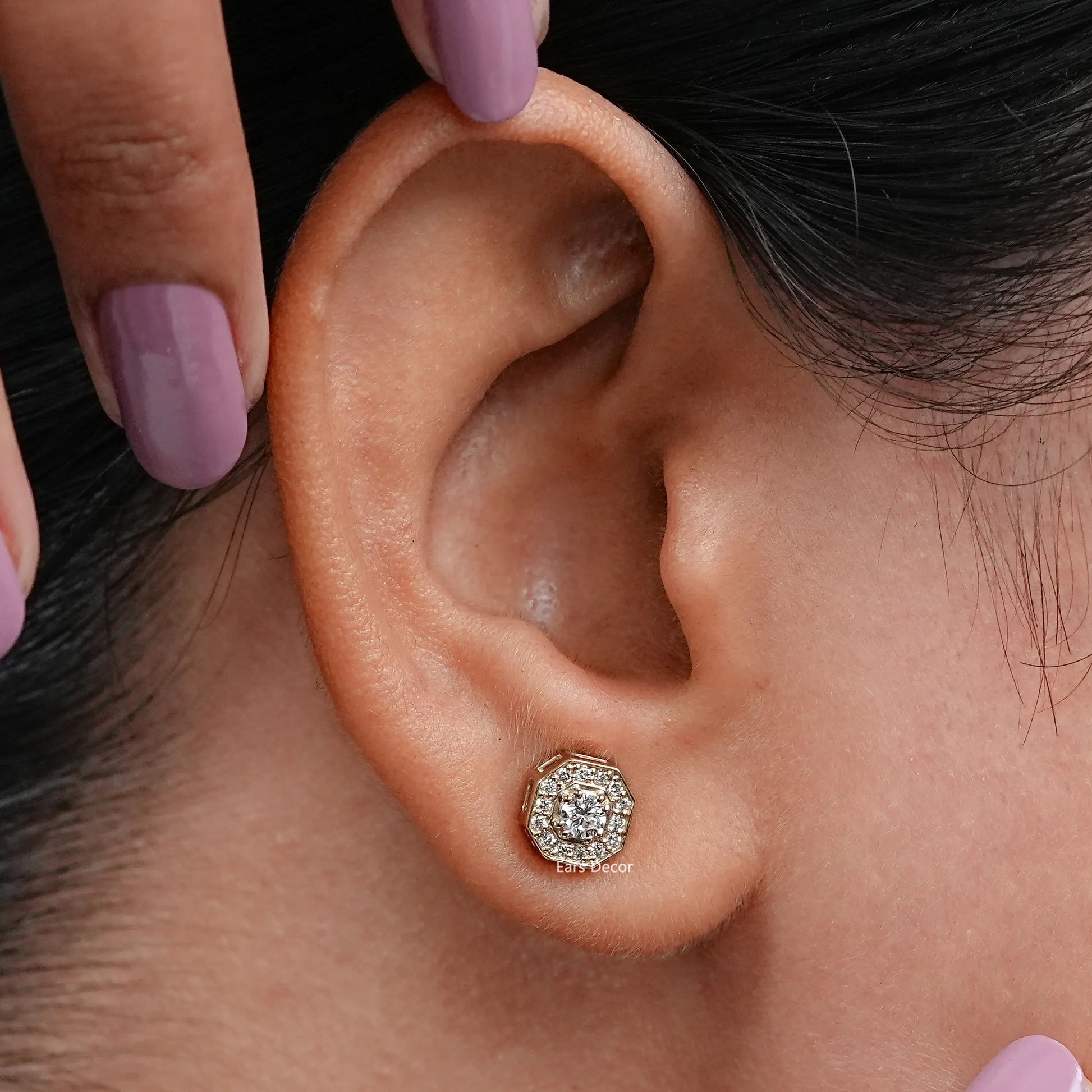 model showcasing a brilliant cut round diamond halo earring in octagon shape