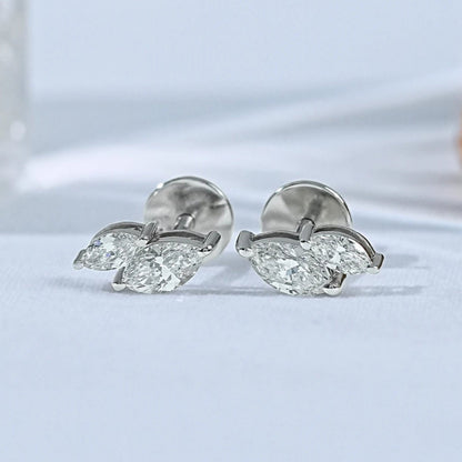 Dainty toi et moi marquise diamond stud earrings 14k white gold two stone design matching pair close-up product shot soft background