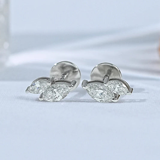 Dainty toi et moi marquise diamond stud earrings 14k white gold two stone design matching pair close-up product shot soft background