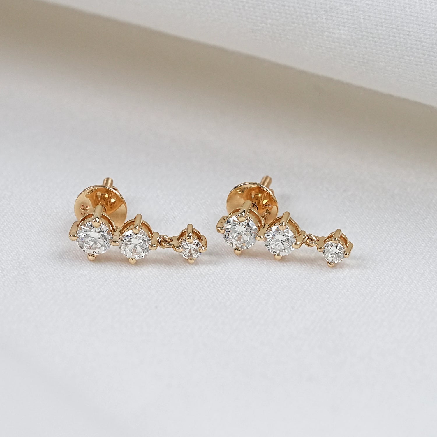 three stone diamond drop earrings in 14k gold front view