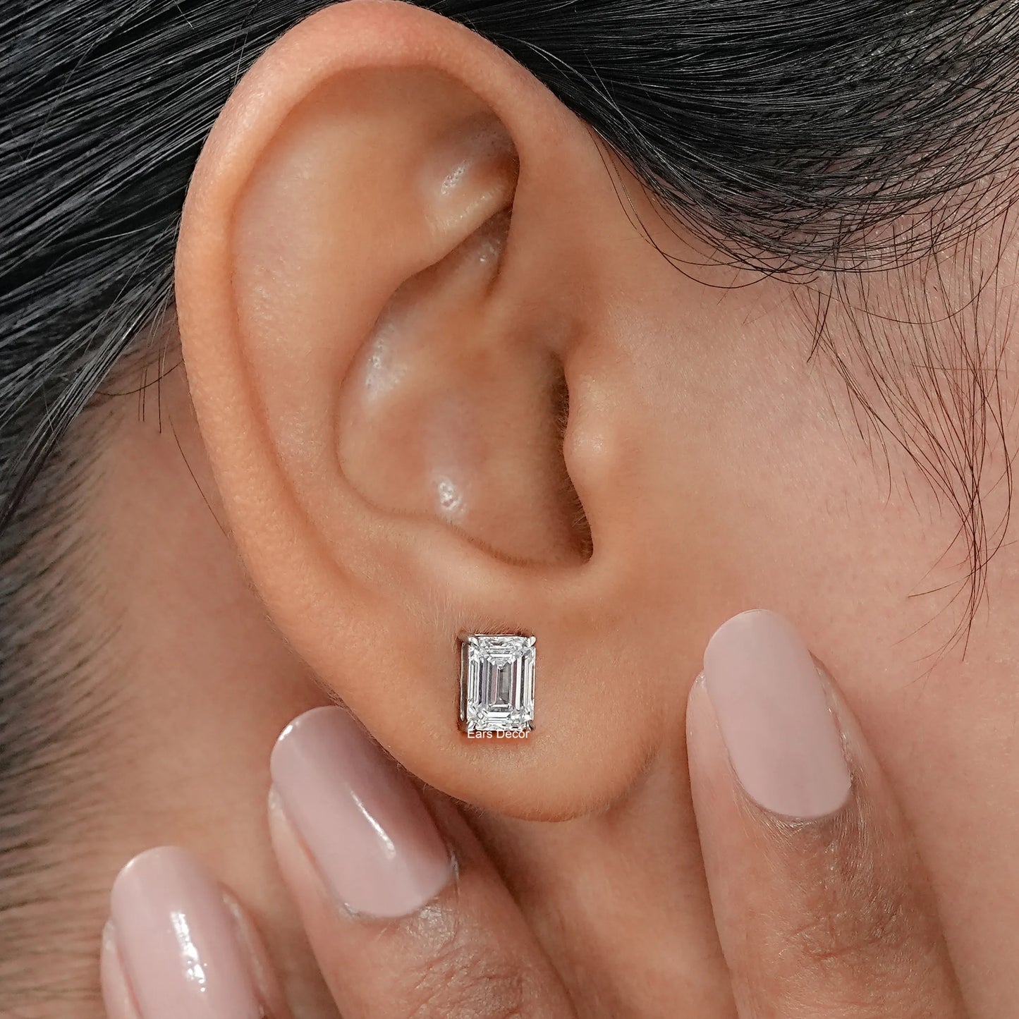 Close macro detail of emerald diamond studs revealing a timeless four prong setting and the remarkable transparency of the lab created stones.