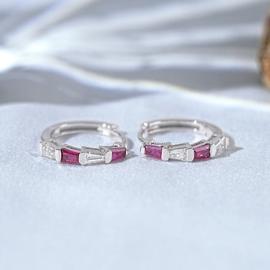 Dainty silver huggie hoop earrings baguette ruby red clear crystal stones pair flat lay white linen coral decor
