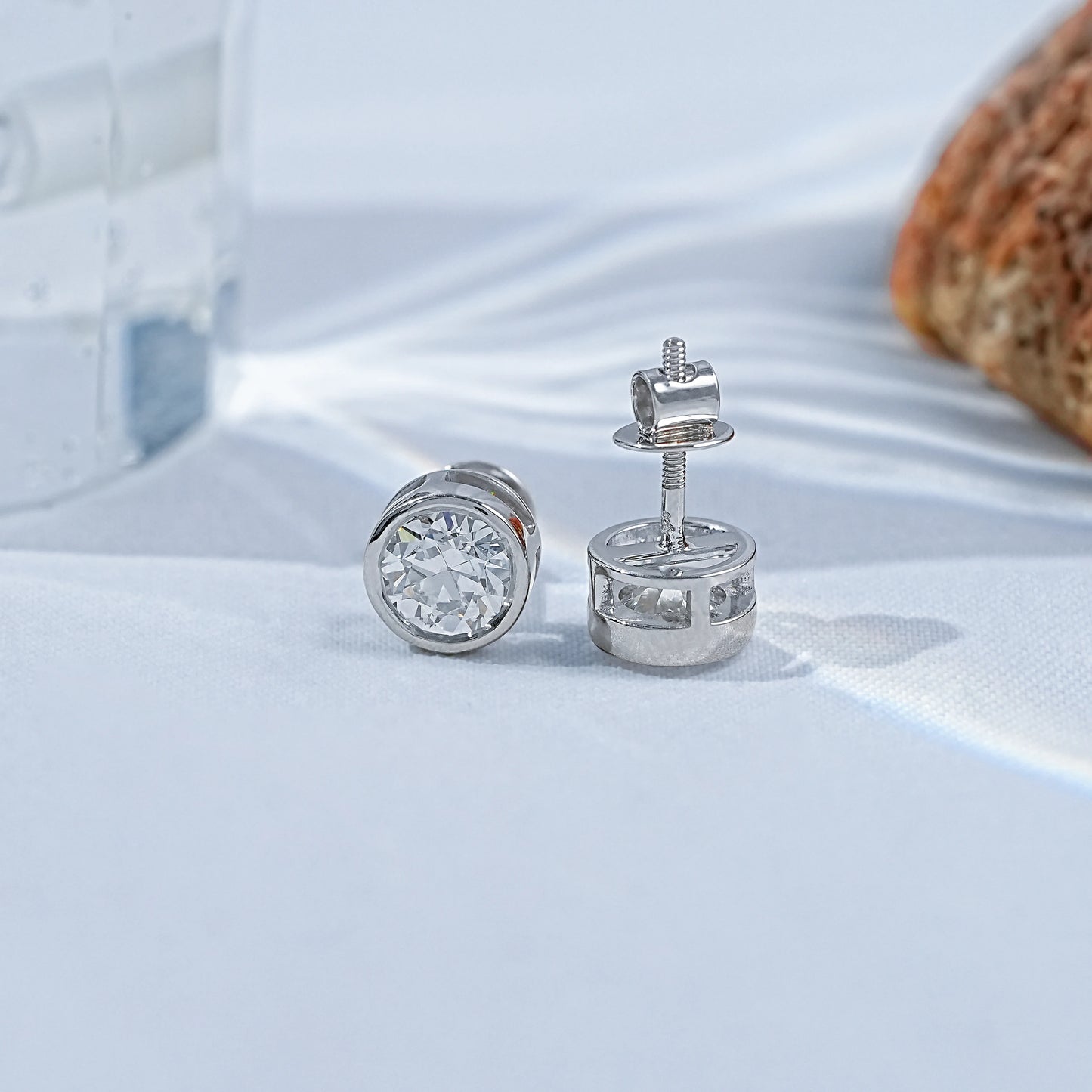Old European round cut lab diamond bezel set stud earrings in 925 silver, showcased on a white background.