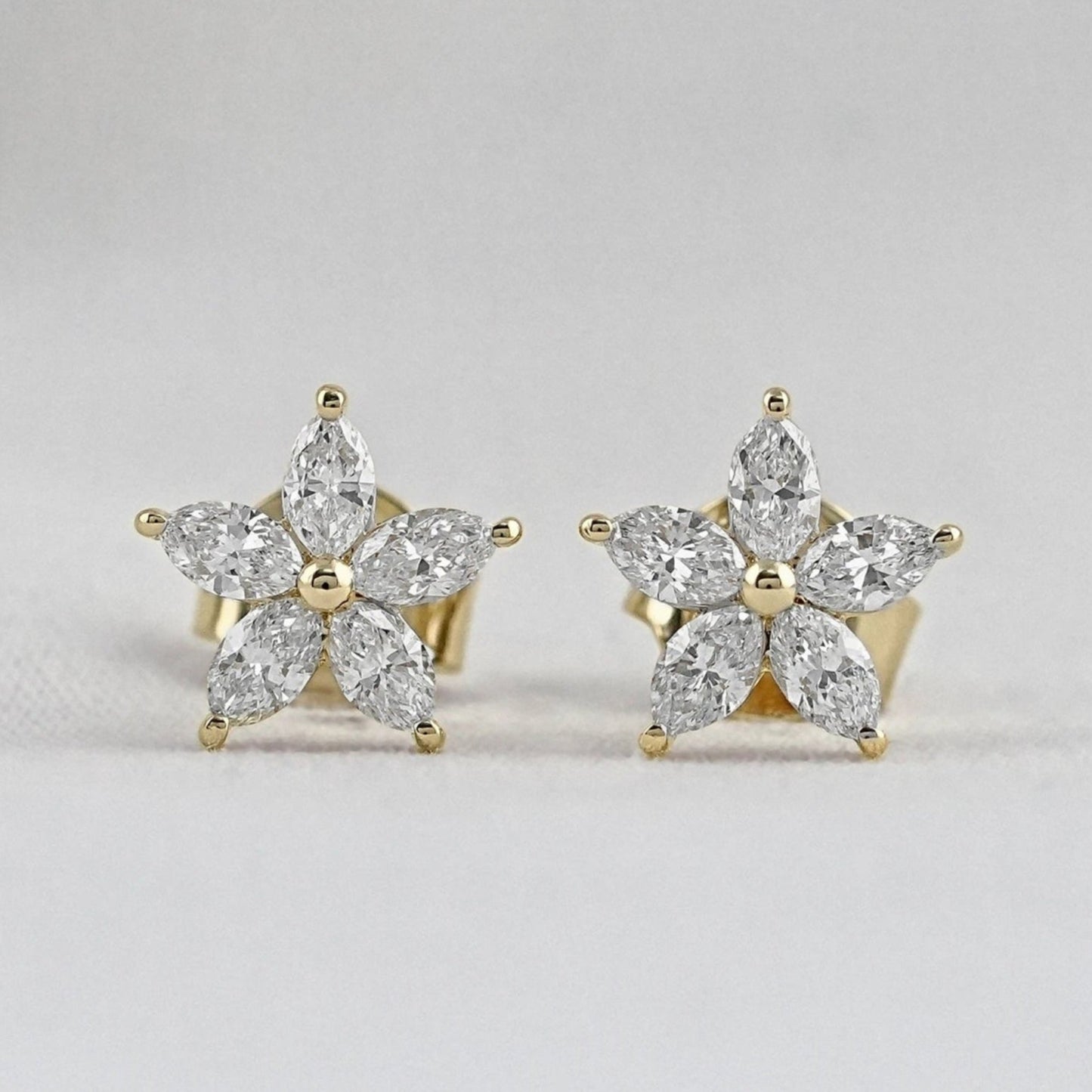 14k yellow gold marquise diamond flower stud earrings for women featuring five brilliant marquise petals around a central gold bead.