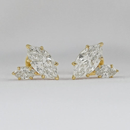 Marquise cut Toi et Moi diamond stud earrings in 14k yellow gold for women brilliant cut diamonds prong setting detail