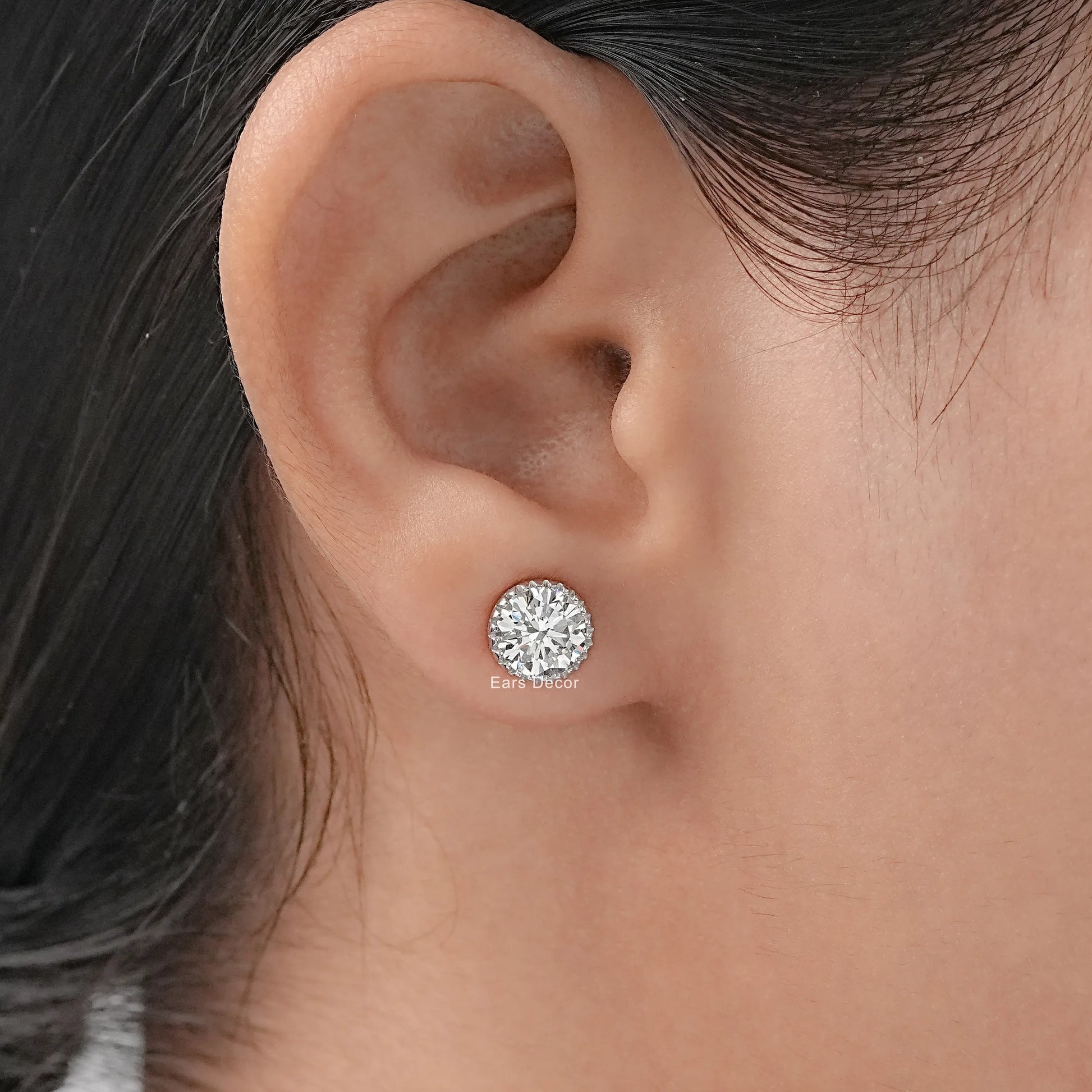 Minimalist moissanite stud earrings for sensitive ears white gold worn on model ear close-up side view