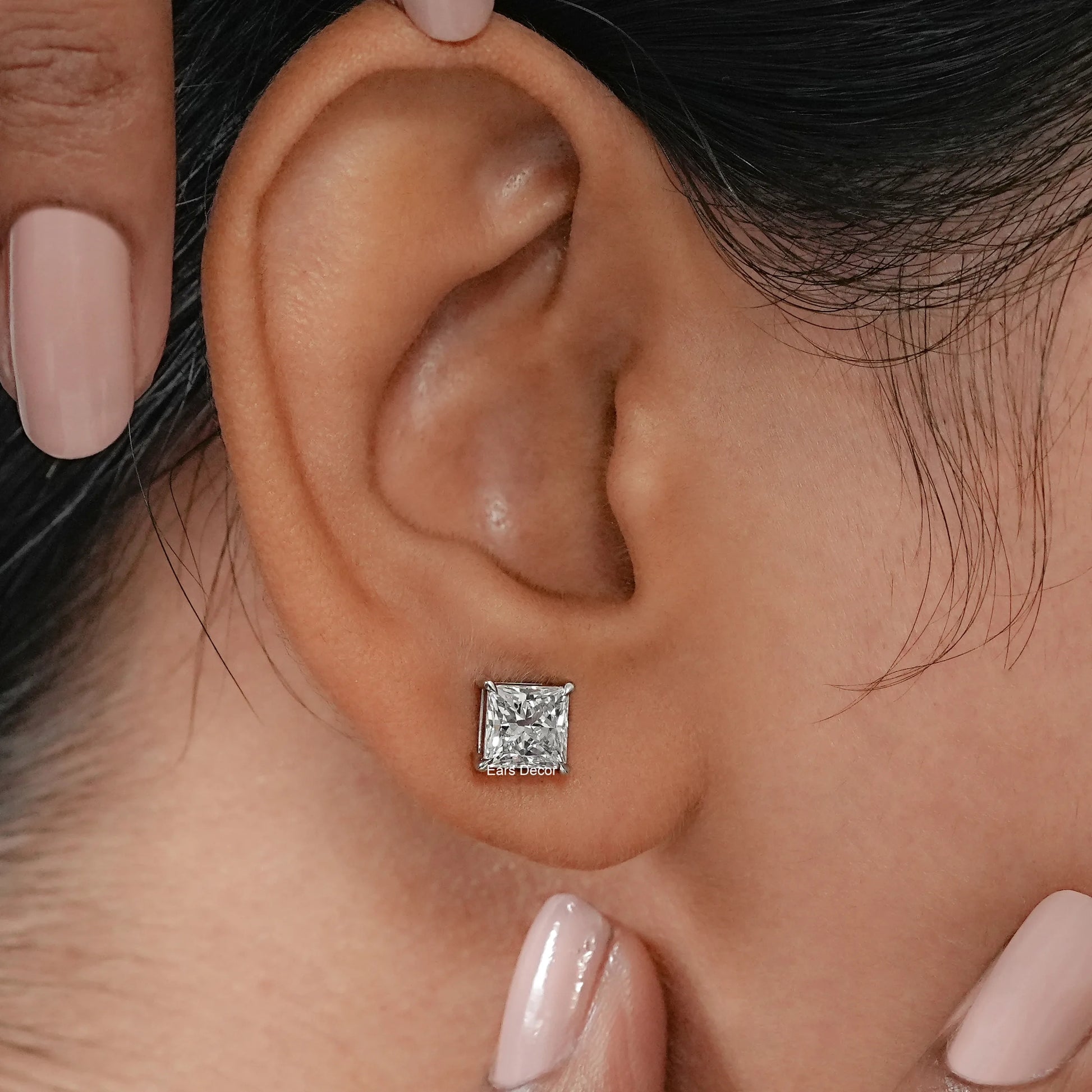 Lab Grown Diamond Solitaire Earrings resting on a polished marble surface to highlight the crisp facets and the posh, hallmarked gold craftsmanship.