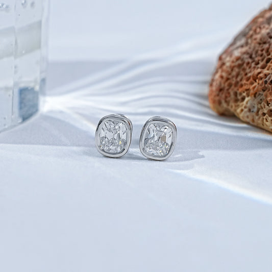 Old Mine Cushion Cut CVD Diamond Stud Earrings in silver, showcasing elegant craftsmanship and sparkle on a soft background.
