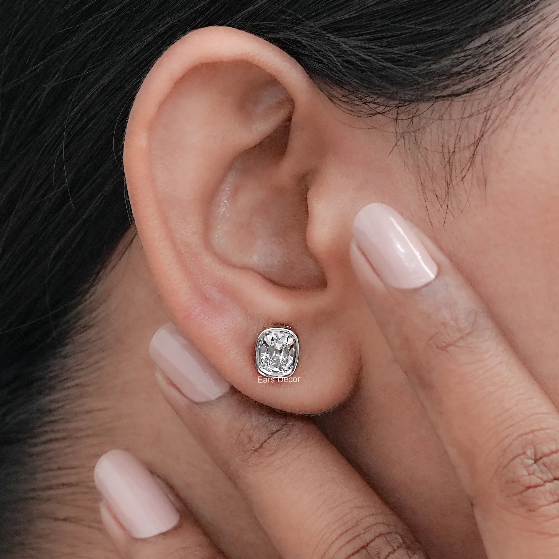 Old Mine Cushion Cut CVD diamond stud earrings showcased on a model's ear, emphasizing elegant diamond details.