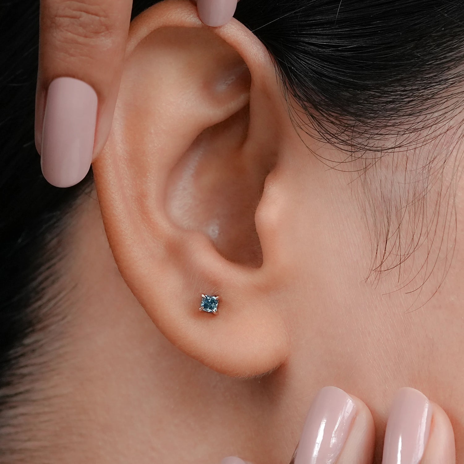 Princess Cut Lab Blue Diamond Stud Earrings captured in a sharp top down view, showcasing the magnificent depth of the azure stones and their crisp, geometric edges for a smashing and modern profile.
