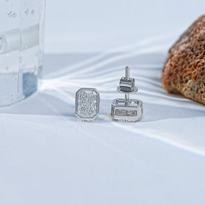 Bezel set radiant cut stud earrings two angles white gold satin, screw-back post visible