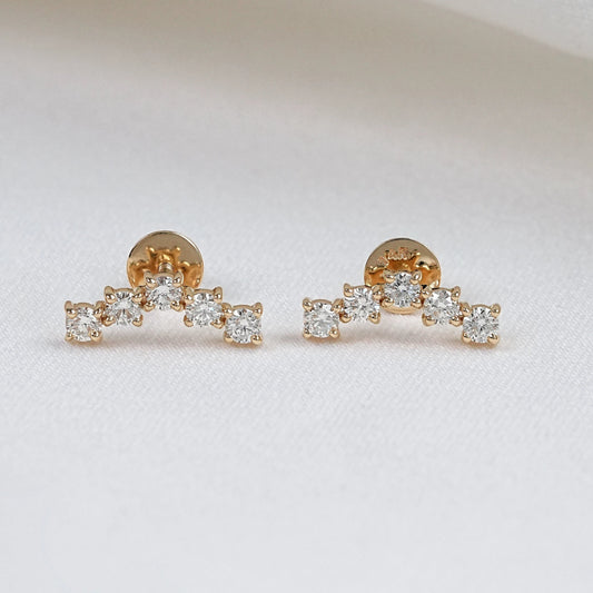 Pair of round cut five stone diamond stud earrings in yellow gold, featuring a curved arc design with prong-set lab diamonds on a white background.