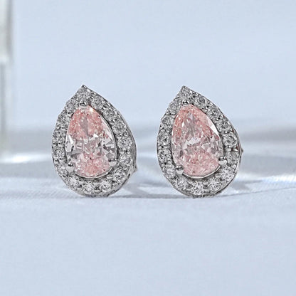 Pear shaped pink diamond stud earrings with double halo white diamond setting white gold matching pair close-up product shot