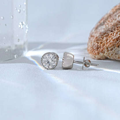 Round brilliant moissanite stud earrings white gold front and back view on white silk fabric flat lay