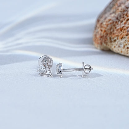 Pair minimalist silver triangle stud earrings screw back closure detail clear crystal stone coastal flat lay seashell white satin background