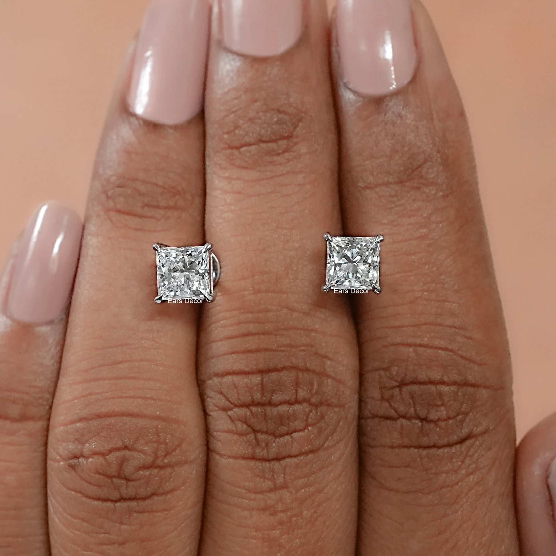 princess cut earrings nestled in a luxury presentation box, showcasing the magnificent fire and the high end, artisan finish of the sustainable stones.