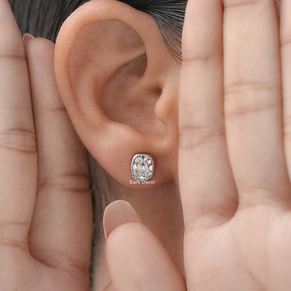 Vintage inspired cushion cut diamond stud earrings white gold milgrain bezel worn model ear both hands framing dark hair warm skin