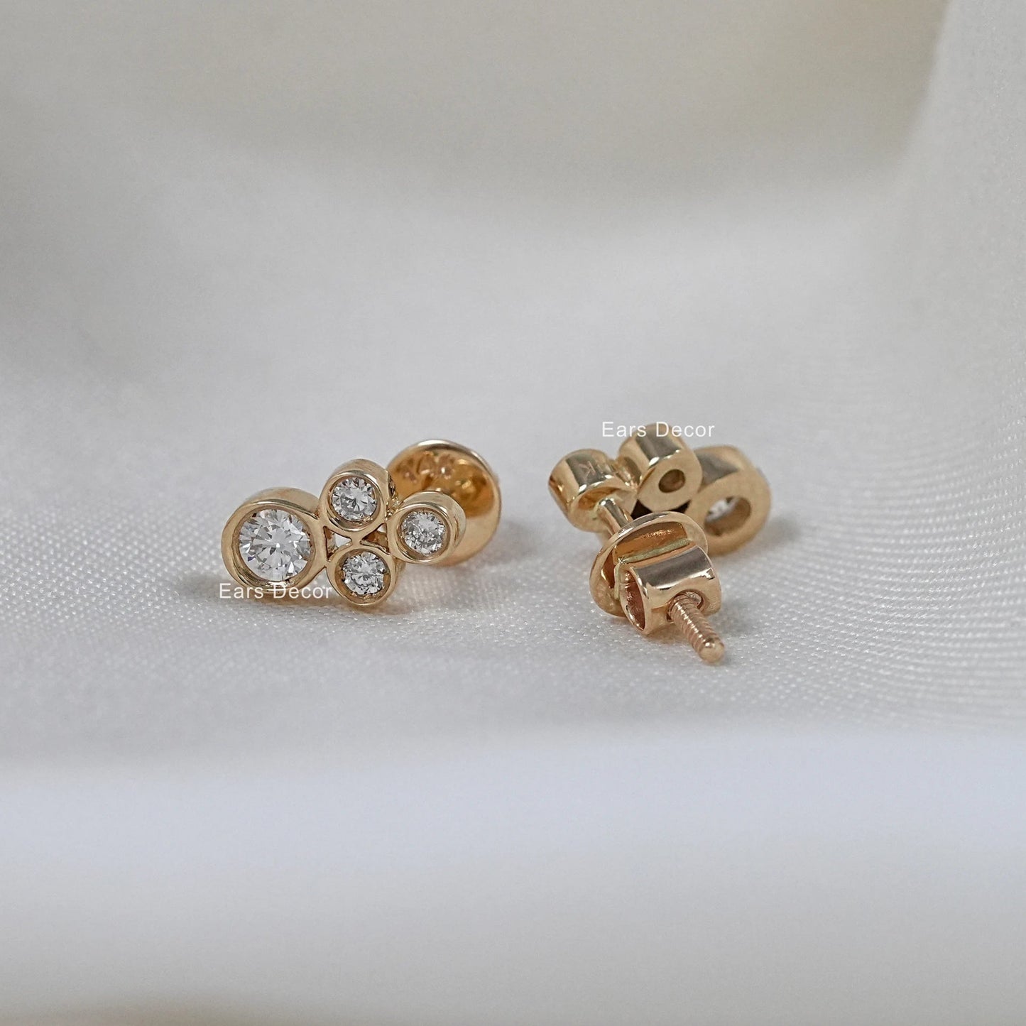 Minimalist diamond stud earrings front and back view on white fabric, screwback post in rose gold