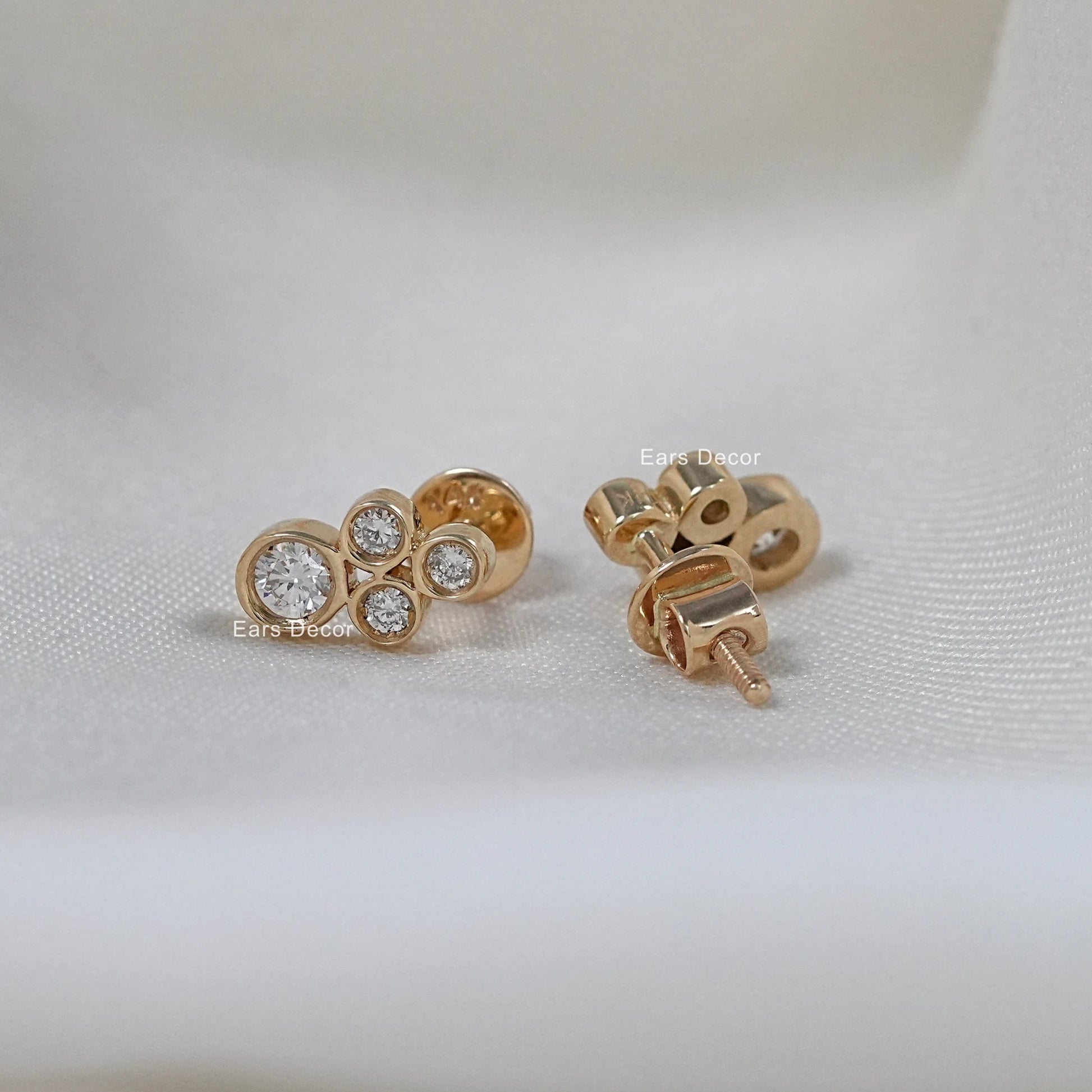 Minimalist diamond stud earrings front and back view on white fabric, screwback post in rose gold
